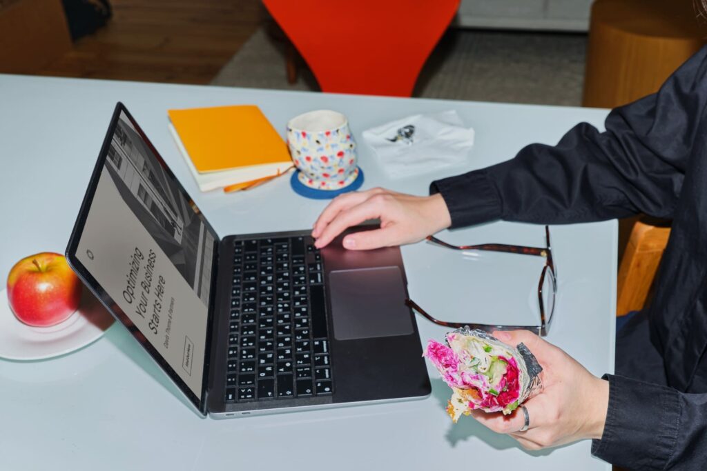 Hands typing on a laptop reflect how The Subtext creates custom Shopify and Elementor web development solutions.