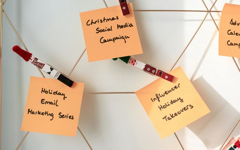 Social media communication plan with campaign ideas and influencer marketing strategy notes on board